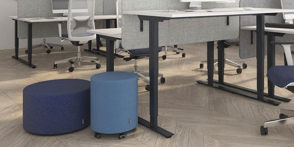 Giro poufs in blue next to Easy sit/stand desks
