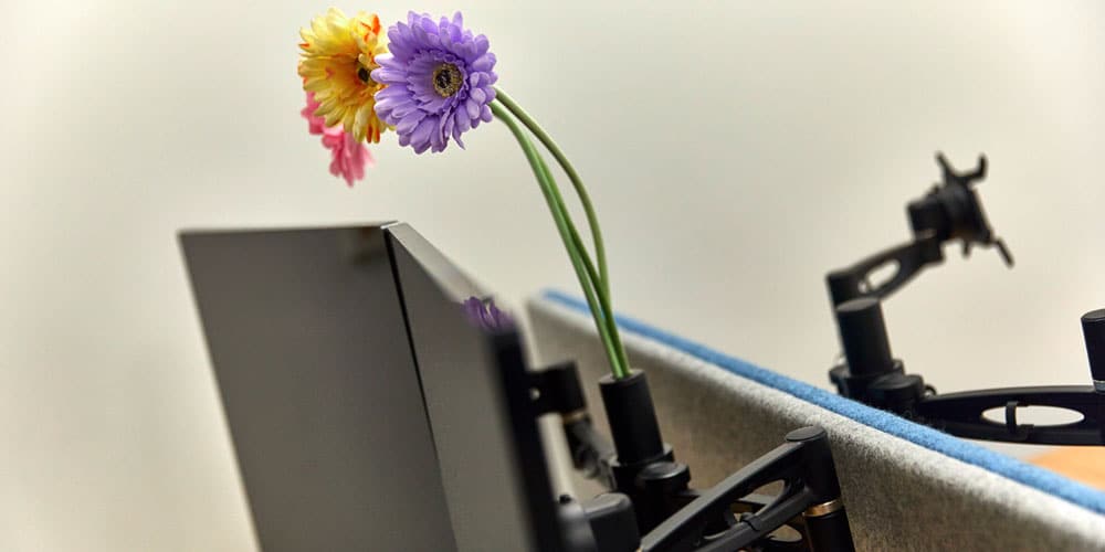 Brighten your workspace with an integrated flower holder in the pole.